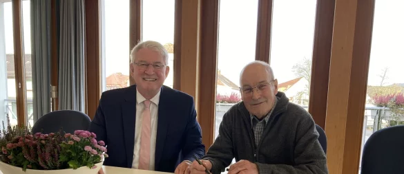 Bodo Diekmann (rechts) trägt sich im Beisein von Bürgermeister Thomas Katzer ins Goldene Buch der Gemeinde ein. - © Cordula Gröne