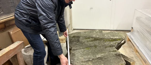 Museumsleiter Dr. Michael Zelle vermisst das Reliefstück aus Sandstein mit einem Zollstock. - © Jan Schillmann