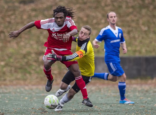 Scorerpunkt zum Geburtstag: Mit einer sehenswerten Einzelleistung zwei Tage vor seinem Geburtstag überwindet Jose Luis Mendes Semedo (rot) vom SV Diestelbruch-Mosebeck den Schlänger Torhüter Dennis Schäferjohann und legt dem einschussbereiten Timo Flecker den Ball passgenau zum 4:0 Endstand vor. Im Hintergrund wird die Szene von Hendrik Erbe (blau) beobachtet. - © Egon Penner
