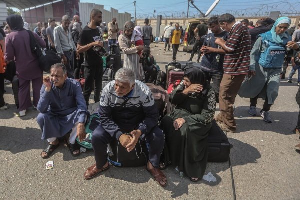 Palästinenser, einige mit ausländischen Pässen, warten am Grenzübergang Rafah auf Hilfe und eine mögliche Einreise nach Ägypten. - © Mohammed Talatene/dpa