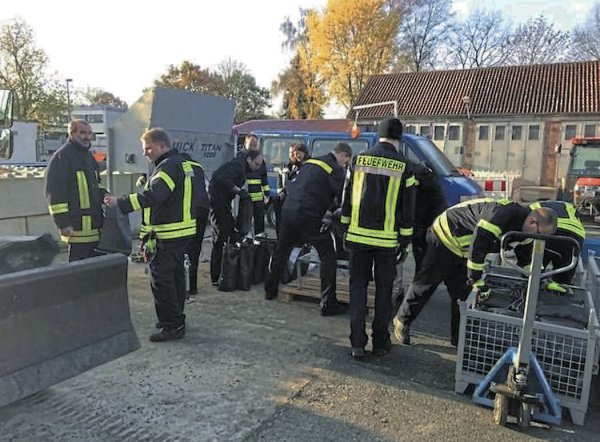 Die Feuerwehr hilft beim befüllen der Sandsäcke. - © Die Stadt Lage