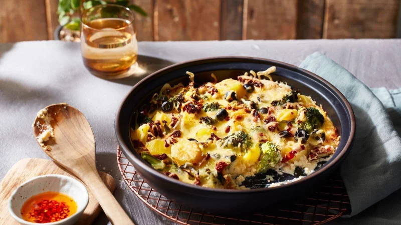 Tomaten und Oliven verleihen dem Kartoffelauflauf einen mediterranen Geschmack. - © KMG/die-kartoffel.de/dpa-tmn