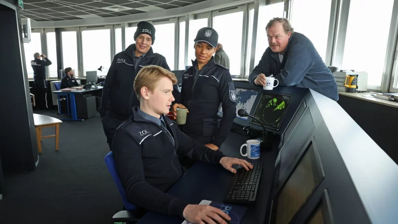 Z&ouml;llner Sven-Erik Dr&ouml;se (Lukas Zumbrock, sitzend) kommt einer hei&szlig;en Spur auf die Schliche in einer Szene aus der Folge &laquo;Gesch&auml;ft mit dem Tod&raquo; aus der Krimireihe &laquo;Der Bremerhaven-Krimi&raquo; - hinten von links nach rechts: Elena Uhlig, Cynthia Micas, Bernd H&ouml;lscher. - &copy; J&ouml;rg Landsberg/Radio Bremen/ARD/dpa