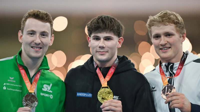 Europameister Nils Dunkel (l) landet am Barren hinter Dario Sissakis. - &copy; Hendrik Schmidt/dpa