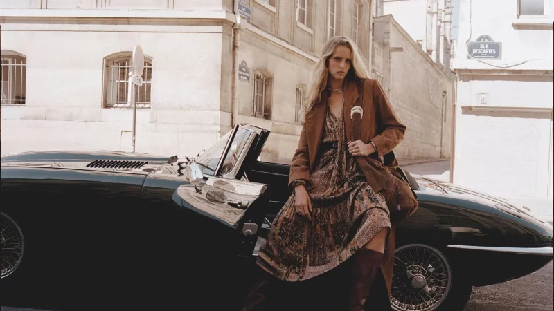 Der Dark Boho Trend - hier von ba&sh - für Herbst/Winter kombiniert die fließende, romantische Ästhetik des Boho-Stils mit dunkleren Farben und Materialien, passend zur kälteren Jahreszeit (Trenchcoat ca. 855 Euro, Handtasche ca. 525 Euro, Stiefel ca. 605 Euro, Kleid ca. 305 Euro). - © ba&sh/dpa-tmn