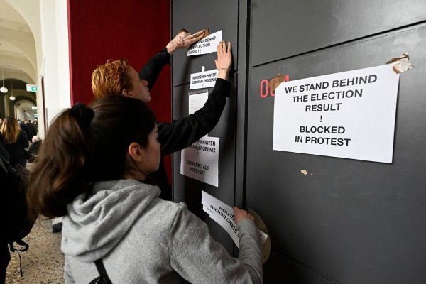 Studenten befestigen Schilder mit der Aufschrift "We stand behind the result!" an ihren Kunsträumen. - © Roberto Pfeil/dpa