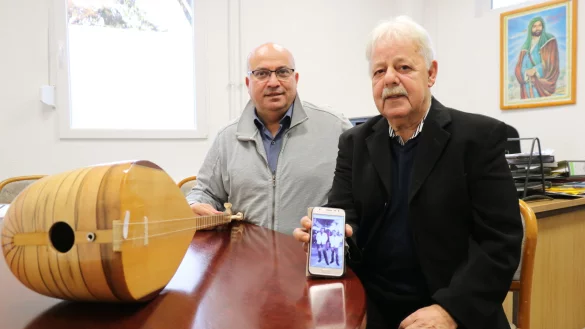 B&uuml;lent Yilmaz (links) hat eine Baglama dabei, ein Instrument aus seiner Heimat. Antonios Stamatopoulos zeigt ein Foto aus den 1970er Jahren, das ihn mit einem griechischen Mitspieler bei einer Saisonabschlussfeier seines damaligen Fu&szlig;ballvereins zeigt. - &copy; Alexandra Schaller