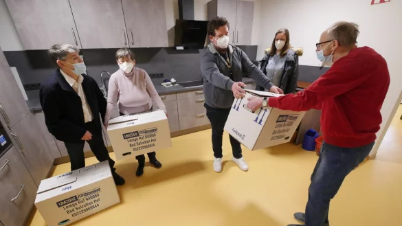Bewohner Peter Paulsen und Ilse Bobe (von links) haben schon Umzugskisten in den neuen Tagestruktur-Bereich der Lebenshilfe-Wohnstätte in der Horner Jahnstraße getragen. Alfons Elsner (ganz rechts) übergibt die letzte an deren Leiter Dominik Behler. Die pädagogische Geschäftsführerin der Lebenshilfe Detmold, Stephanie Kleine, schaut zu.  - © Jost Wolf