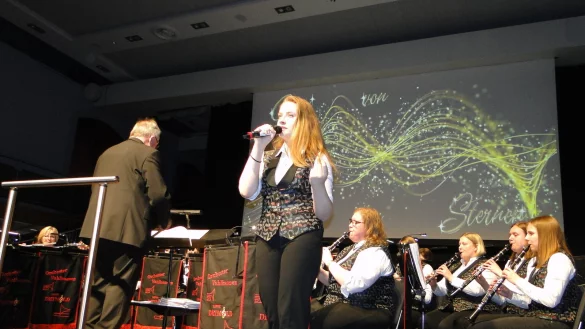 G&auml;nsehautmoment beim Stadthallen-Konzert des Orchesters Vahlhausen: Saxophonistin Kimberley Moor greift zum Mikrofon und singt inbr&uuml;nstig "Ich hole euch Gold von den Sternen". Die Vokal-Einlage ist eine Neuerung im Design der sinfonischen Blasmusik. (Foto: Hajo G&auml;rtner) - &copy; Hajo G&auml;rtner