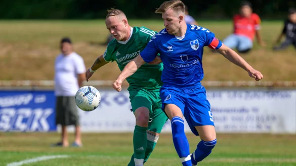 Intensive Zweik&auml;mpfe - In dieser Szene k&auml;mpft der Salzufler Kapit&auml;n Maximilian Leitmann und sein Ahmser Kontrahent S&ouml;ren Seifert (gr&uuml;n, links) um den Ball. - &copy; Egon Penner