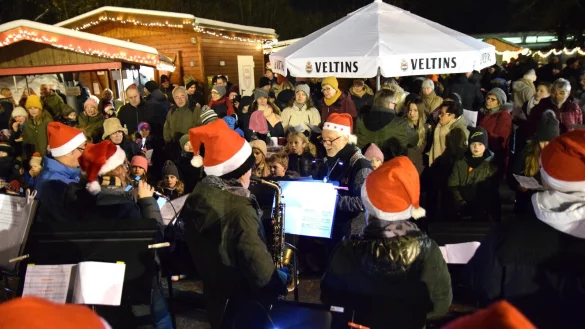 Die Big Band der Oerly-Musikschule zieht mit dem Singen traditioneller Weihnachtslieder viel Publikum an. Auf dem Sportgel&auml;nde tummeln sich viele Besucher. - &copy; Karin Prignitz