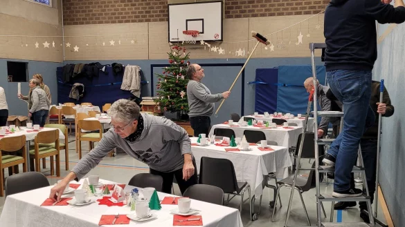 Gisela St&ouml;cker richtet auf den Tischen die letzten Details, Rainer Deppe schwingt den Besen, um die Sterne auszurichten. Jan L&uuml;decke und Erno St&ouml;cker(rechts) haben sie auf die Leine gef&auml;delt. Am Samstag waren 90 &auml;ltere Hagener eingeladen, zwei sch&ouml;ne Stunden in der Schulturnhalle zu verleben. - &copy; Astrid Sewing