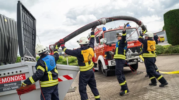 Die L&ouml;schgruppe Alverdissen beim Durchf&uuml;hren der &Uuml;bung, im Hintergrund ihr 36 Jahre altes L&ouml;schfahrzeug mit einer Vorbaupumpe. - &copy; FreitagTV