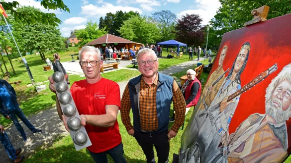 Detlef Kuhlmann von der Dorfgemeinschaft und K&uuml;nstler Ulrich Tasche (von links) freuen sich &uuml;ber den regen Zulauf auf der Siekwiese, auf der Kunst gezeigt, Pickerts serviert werden und Boule ausprobiert werden kann - &copy; Nicole Ellerbrake