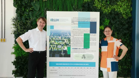BiUH-Pr&auml;sident Prof. Dr. J&uuml;rgen Kretschmann und Kanzlerin Prof. Dr. Guan Naijia vor einem Plakat mit dem Bauvorhaben f&uuml;r den Campus der neuen Hochschule. - &copy; Ziwei Du/BiUH