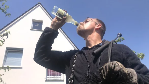 Schornsteinfeger Tim Horst-B&auml;umer kennt keinen Schmerz. Ganz in Schwarz steigt er den Menschen trotz der tropischen Temperaturen aufs Dach und in die Gottseidank k&uuml;hleren Keller. Sein Kommentar: "Nutzt ja nix". - &copy; Martin Hostert