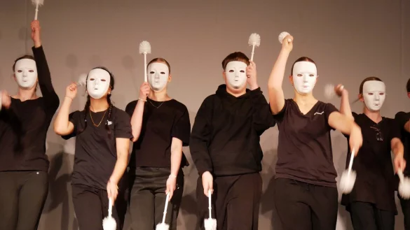 Let's go! Mit wei&szlig;er Neutralmaske und Klob&uuml;rste. Sch&uuml;lerinnen und Sch&uuml;ler der Jahrgangstufe 7 gestalten Szenencollagen zum Thema "Unterwegs sein" und "Sich auf den Weg machen". - &copy; Thomas Kr&uuml;gler