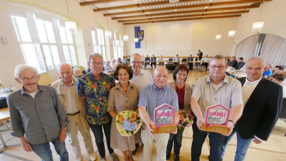 Vor der Ratssitzung verleiht B&uuml;rgermeister Heinz-Dieter Kr&uuml;ger (rechts) die Heimatpreise, deren Gewinner er schon Ende 2022 im Rat verk&uuml;ndet hatte. Es habe Lieferschwierigkeiten bei den Troph&auml;en gegeben. Daf&uuml;r kann die Stadt nichts, aber es passte perfekt ins Bild der konfusen Ratssitzung voller Pleiten und Pannen. - &copy; Jost Wolf