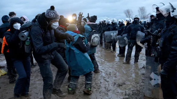 Polizisten und Demonstranten stehen sich am Rande des Braunkohletagebaus bei L&uuml;tzerath gegen&uuml;ber. - &copy; Oliver Berg