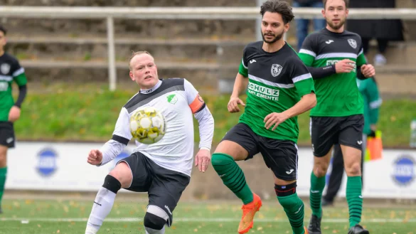 Aktivposten - TUS-Ahmsens Kapit&auml;n J&ouml;rn Seifert (wei&szlig;, links) kniet sich gegen seinen Oerlinghauser Kontrahenten Christian P&ouml;rtner (gr&uuml;n, rechts) voll rein. Foto: Egon Penner. - &copy; Egon Penner