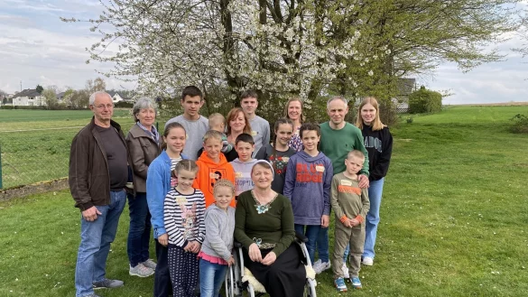 Johann und Helene Wins (links) unterstützen die Familie Korchak. Dazu gehören die Eltern Ludmilla und Igor sowie Großmutter Alla im Rollstuhl und die Kinder Alexander, Ernest, Victoria, Julia, Tatjana, David, Vladislaw, Daniel, Anna, Nicol und Yelisei. - © Dirk Windmöller