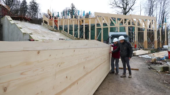 Museumsleiterin Dr. Marie Luisa Allemeyer und Simon Waigand vom Architekturbüro ACMS stehen vor einem der Holzträger - im Hintergrund entsteht aktuell die Holzkonstruktion für das neue Eingangsgebäude des Freilichtmuseums, links daneben führt später eine imposante Treppe nach oben. - © Alexandra Schaller