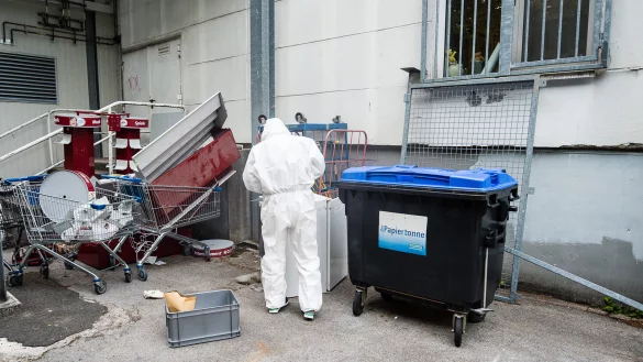 Spurensicherung: Ein Kriminalist untersucht den Fundort der Leiche, entdeckt in dem Papiercontainer. - &copy; CHRISTIAN MATHIESEN