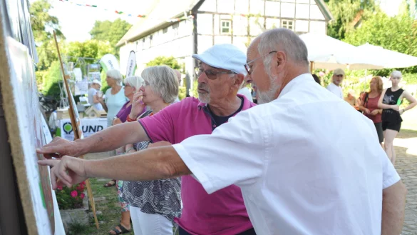 Informationen zur Nordumgehung: Karl-Ludwig Tracht von der B&uuml;rgerinitiative &bdquo;Pro Ilsetal" (rechts) mit Besucher Gunter Voigt an einer Infotafel beim Sommerfest an der Steinm&uuml;hle. - &copy; Nicole Ellerbrake