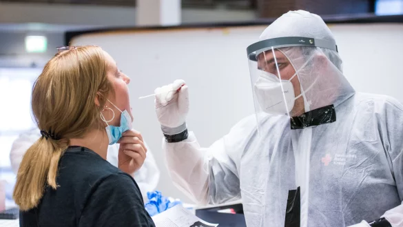 Eine Reiser&uuml;ckkehrerin l&auml;sst sich am Flughafen auf das Coronavirus testen. Seit Samstag m&uuml;ssen Einreisende aus Risikogebieten einen Abstrich machen. Anderen Urlaubern steht es frei, einen kostenlosen Test in Anspruch zu nehmen. - &copy; Daniel Bockwoldt/dpa