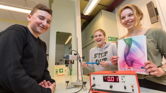 (von links) Emre, Christiane und Annalena nehmen auch Technik aus der Physiksammlung des Gymnasiums zu Hilfe, um Produkte wie Collegeblöcke auf Herz und Nieren zu testen. - © Foto: Gocke