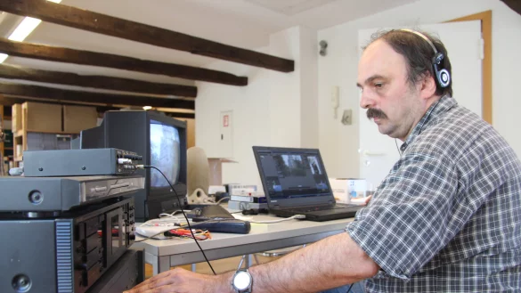 Digitalisierungsprojekt im Stadtarchiv: Mitarbeiter Sven Schmidt sitzt konzentriert an seinem Arbeitsplatz im Süsterhaus und überspielt alte VHS-Kassetten und Super-8-Filme auf den Rechner. - © Tobias Schneider