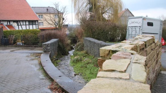 Wo einst eine Br&uuml;cke &uuml;ber den Holzhauser Bach f&uuml;hrte, verhindern jetzt Gabionen von zweifelhafter Sch&ouml;nheit, dass man ins Wasser f&auml;llt. In diesem Bereich kann sich der SPD-Ortsverein einen Rastplatz f&uuml;r Wanderer vorstellen, der auch gleichzeitig als Dorftreffpunkt dienen soll. - &copy; Dieter Asbrock