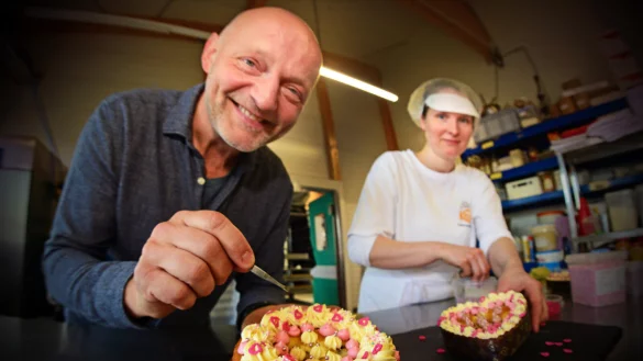J&ouml;rg Meffert und Konditorin Antonia Althof zeigen ein Dekobeispiel f&uuml;r die Muttertagstorte.&nbsp; - &copy; Nicole Ellerbrake
