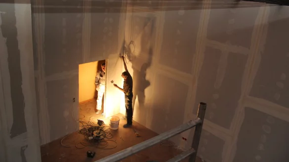 Blick von oben: Derzeit haben die Trockenbauer in der ehemaligen Aula der Volkshochschule das Sagen. Selbst die Trennw&auml;nde, die aus der rund 16 Meter langen Halle k&uuml;nftig f&uuml;nf Seminarr&auml;ume machen, sind noch vier Meter hoch. - &copy; Stefan Backe