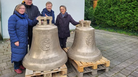 Dagmar Hense, Vorsitzende des Pfarrgemeinderates, Gemeindereferent Franz-Herbert Hense, Hubert Sprint, Förderverein in Liebfrauen und Karin Plöger vom Pfarrgemeinderat (von links) umfassen die neuen Glocken für den Turm der Liebfrauenkirche. Im Hintergrund wird eine der alten Glocken gerade hinaufgezogen. - © Freya Köhring