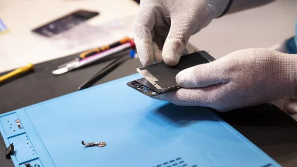 Ein Mann repariert ein Smartphone - &copy; Foto: Florian Schuh/dpa-tmn