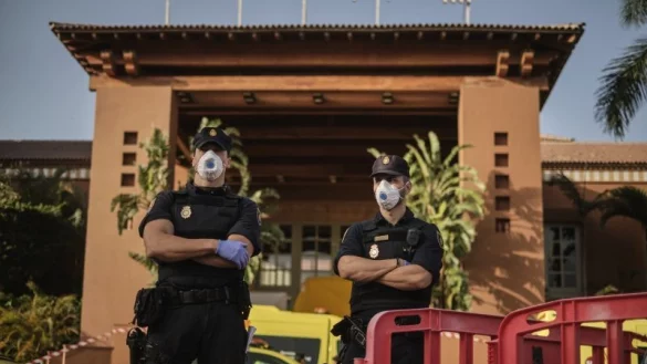 Polizisten mit Mundschutz stehen an einem Kontrollpunkt vor dem Hotel H10 Costa Adeje Palace. - &copy; Str/AP/dpa