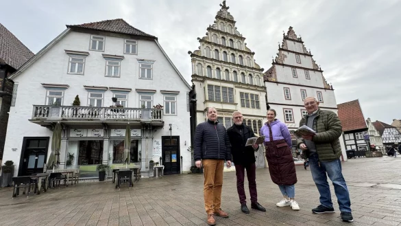 Stefan Wiesekopsieker (von links, Lippischer Heimatbund), Autor Walter Theiler, Inga Bernhard (Stadtarchiv) und Dieter Homann vor drei Geb&auml;ude am Markt, die einst der Familie Barkhausen geh&ouml;rten. - &copy; Sven Kienscherf