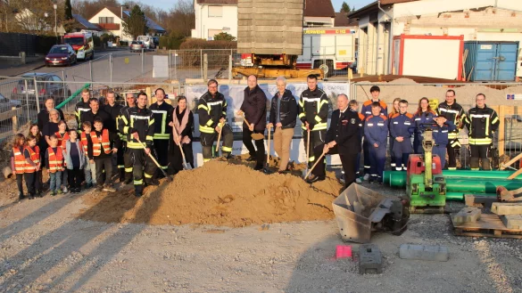 Christopher Schramm (stellvertretender Löschgruppenführer Cappel, vorne von links), Juliane Mauermann (Projektleitung der BIG), Martin Brächtker (Löschgruppenführer Cappel), Bürgermeister Christoph Dolle, Architekt Stefan Brand, Cord Finke (stellvertretender Wehrführer) und Joachim Hartfelder (Wehrführer) setzen gemeinsam den ersten Spatenstich für das neue Feuerwehrgerätehaus in Cappel. Auch Mitglieder der Kinder- sowie der Jugendfeuerwehr und weitere Gäste sind bei diesem Ereignis dabei. - © Stadt Blomberg