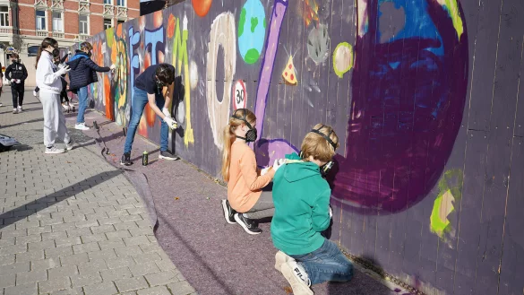 Mit Atemschutzmasken, Spraydosen und Malerrollen haben sich die jungen Kreativen am Bauzaun verewigt. - &copy; Stadt Detmold
