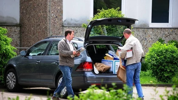 Kripobeamte tragen Beweise aus der Wohnung des Mordopfers und verstauen sie in ihrem Fahrzeug. - &copy; FOTO: CHRISTIAN MATHIESEN