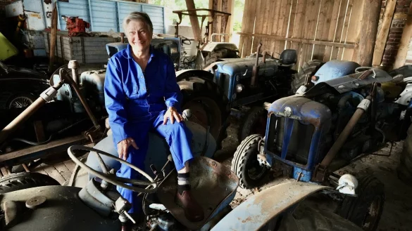 Marianne Lütkehölter sitzt auf einem der Ford-Oldtimer-Trecker, die ihr verstorbener Mann gesammelt hat. - © Peter Unger
