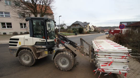 Mitarbeiter der Firma Tewes aus Bad Driburg transportieren die letzten Absperrungen am Hackemackweg ab. Stra&szlig;e und Kan&auml;le sind fertig saniert. - &copy; Jens Rademacher