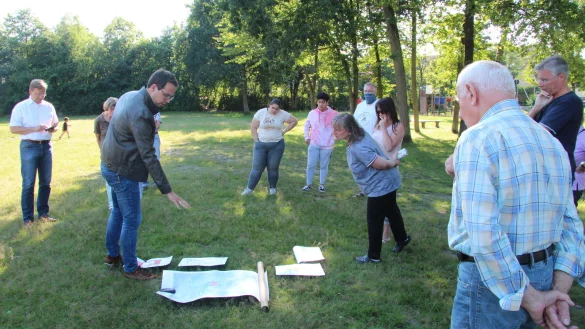 Manuel Br&ouml;ker (Fachbereich Bauen, Planen, Umwelt) erl&auml;utert den Anwohnern des Spielplatzes Schlesierstra&szlig;e anhand von Pl&auml;nen, wie der Bolzplatz aufgewertet und das Gel&auml;nde insgesamt barrierefrei gestaltet werden soll. Links B&uuml;rgermeister Dr. Andreas J. Wulf. - &copy; Dieter Asbrock